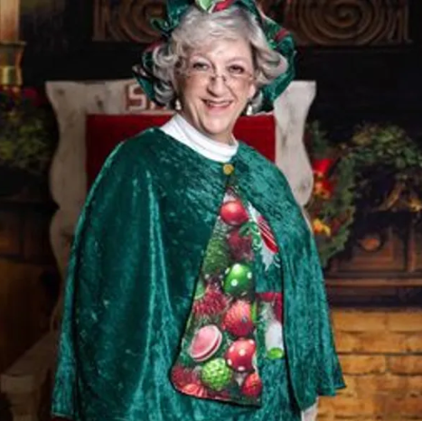 Mrs. Claus in festive green cape