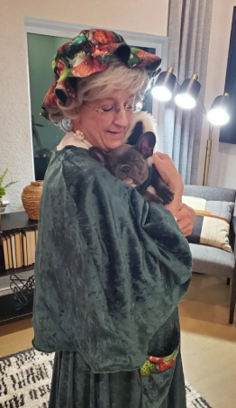 Mrs. Claus holding a puppy