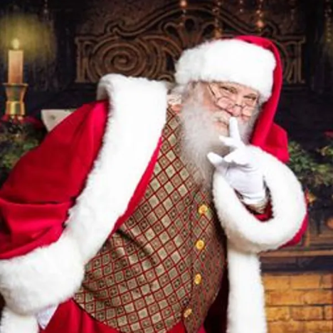 Santa Claus with finger to lips in a festive setting
