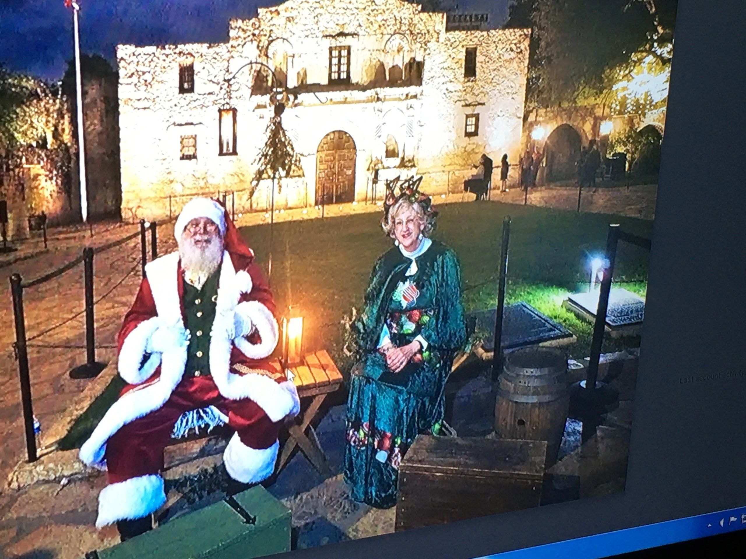 Santa and Mrs. Claus in front of illuminated castle