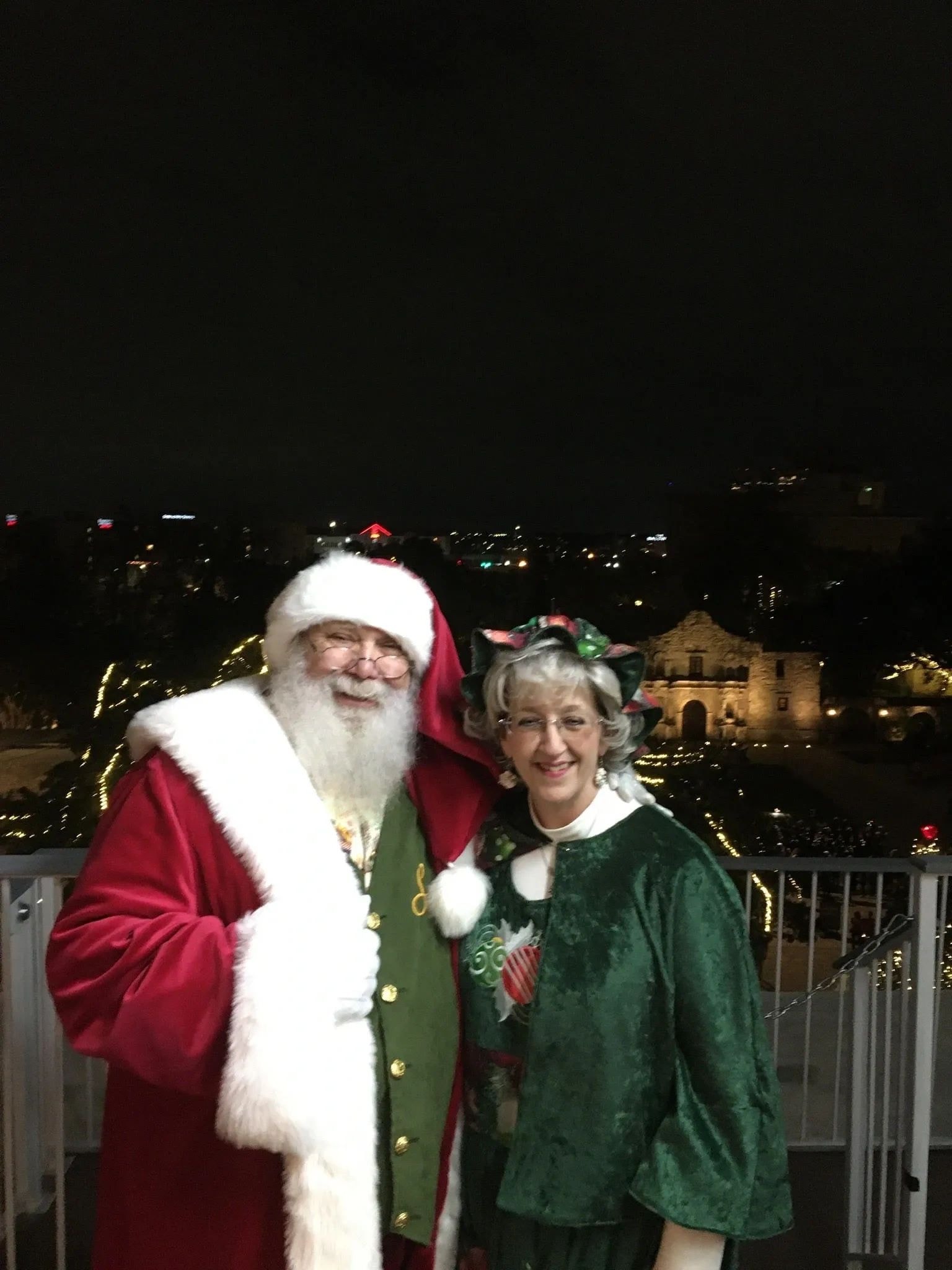 Santa and Mrs. Claus portrait with holiday lights